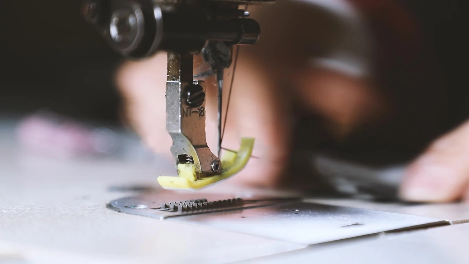 Close-up of fabric being stitched with a sewing machine